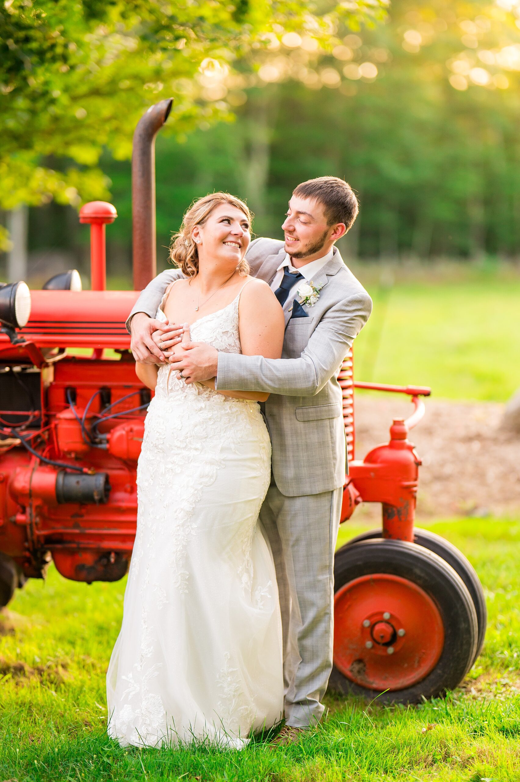 bride and groom by tractor at Tumbledown Farm Wedding 