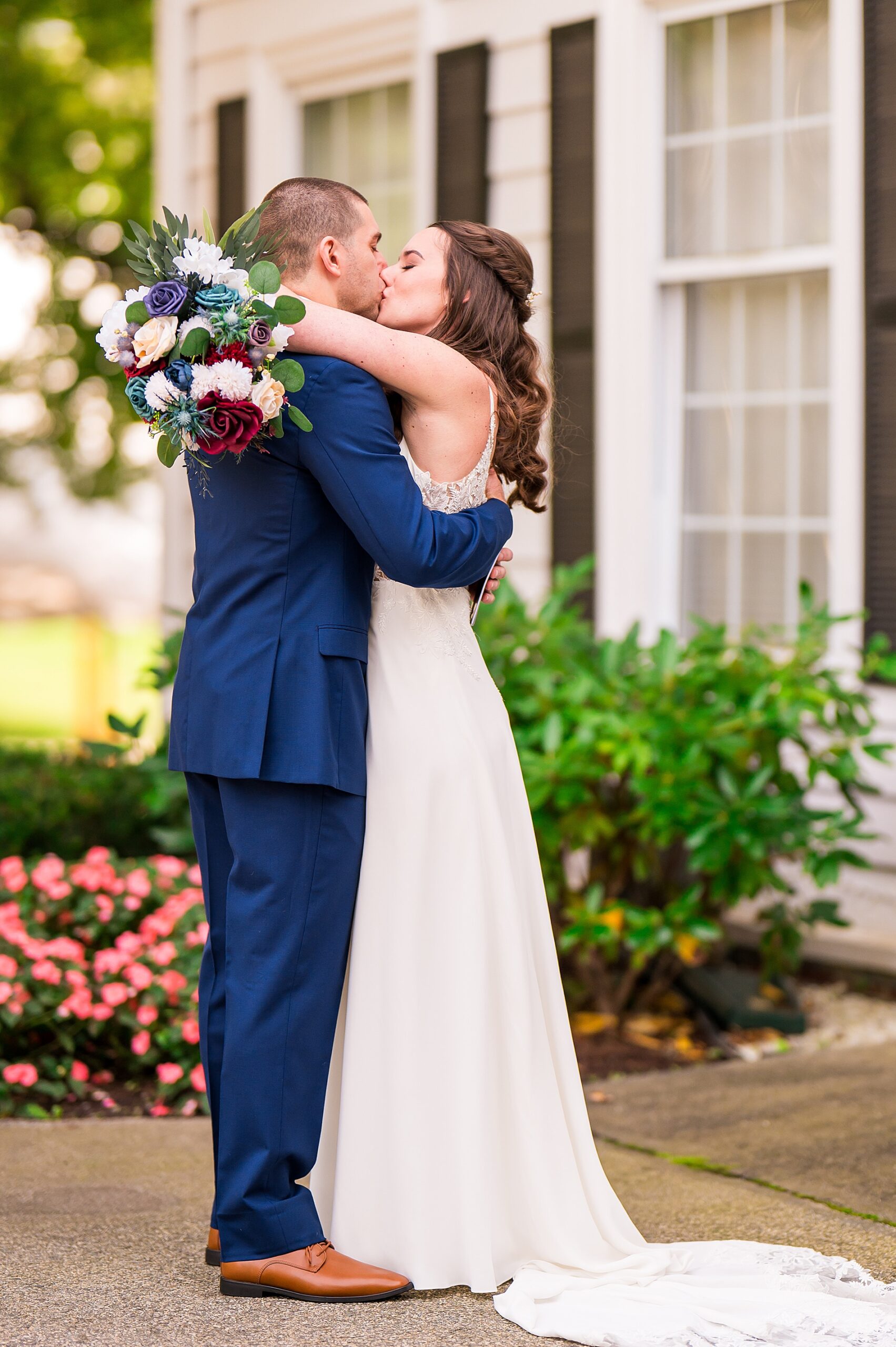 bride and groom kiss during intimate first look moment