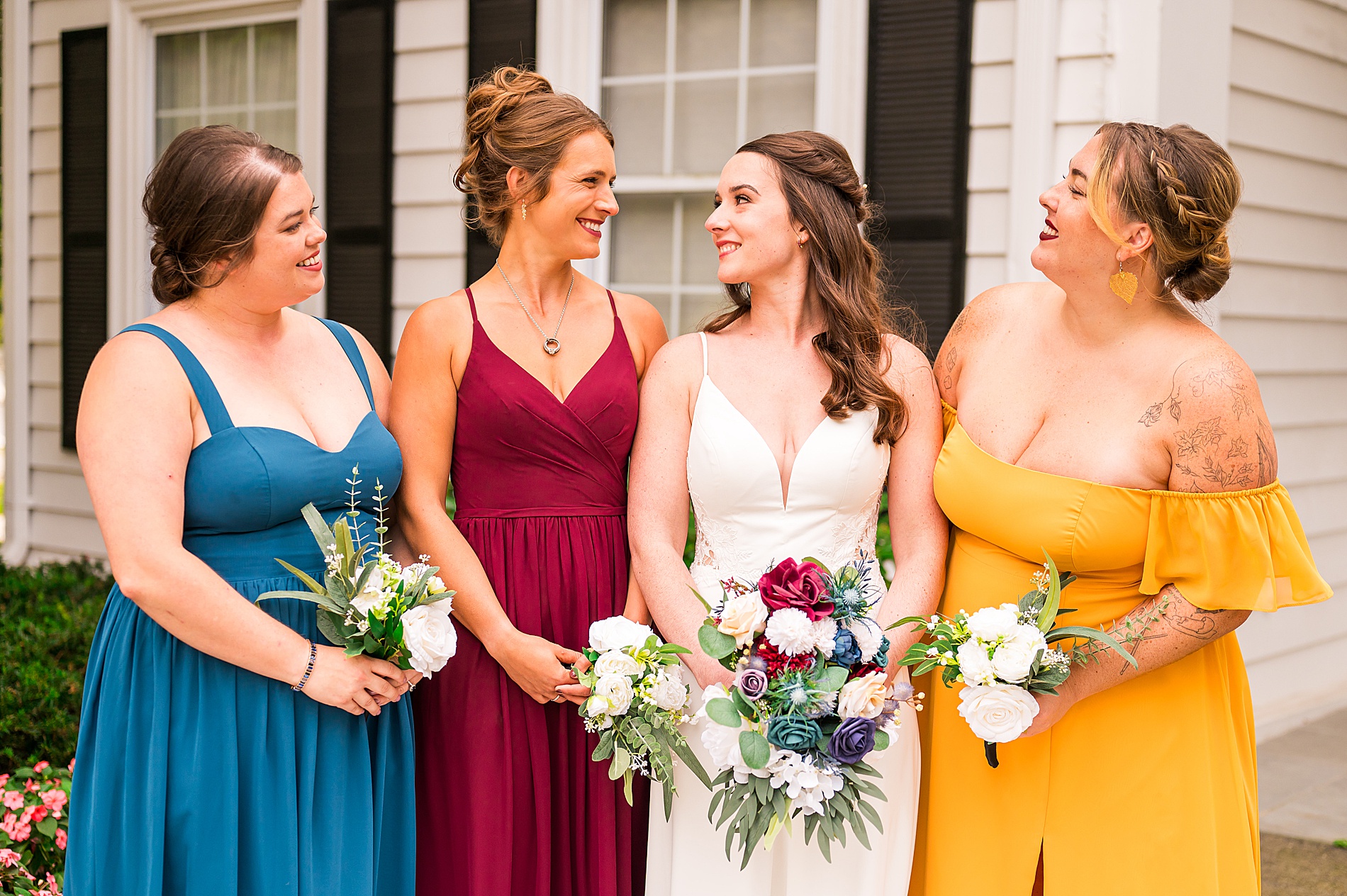 bridesmaids in deep jewel toned dresses 