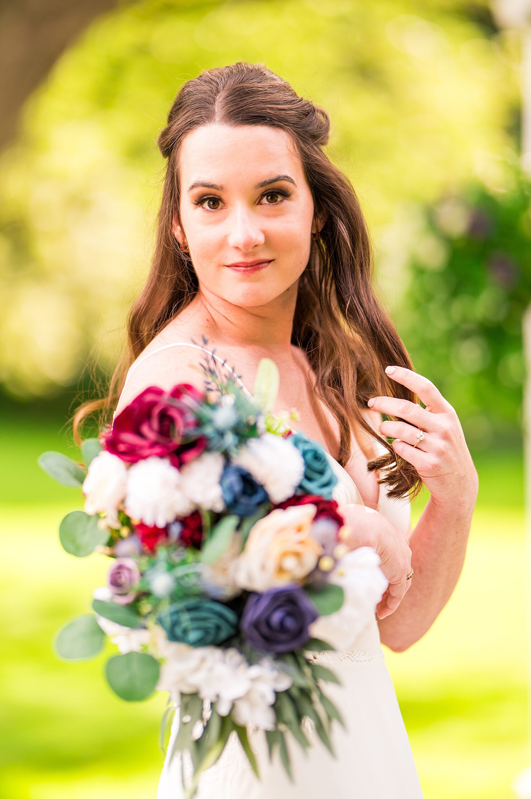 bridal portraits holding deep jewel toned flower bouquet 