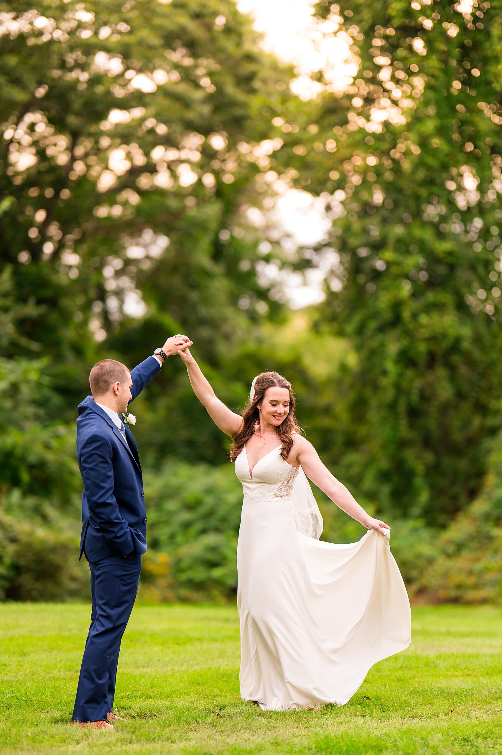 newlyweds dance during candid wedding portraits 