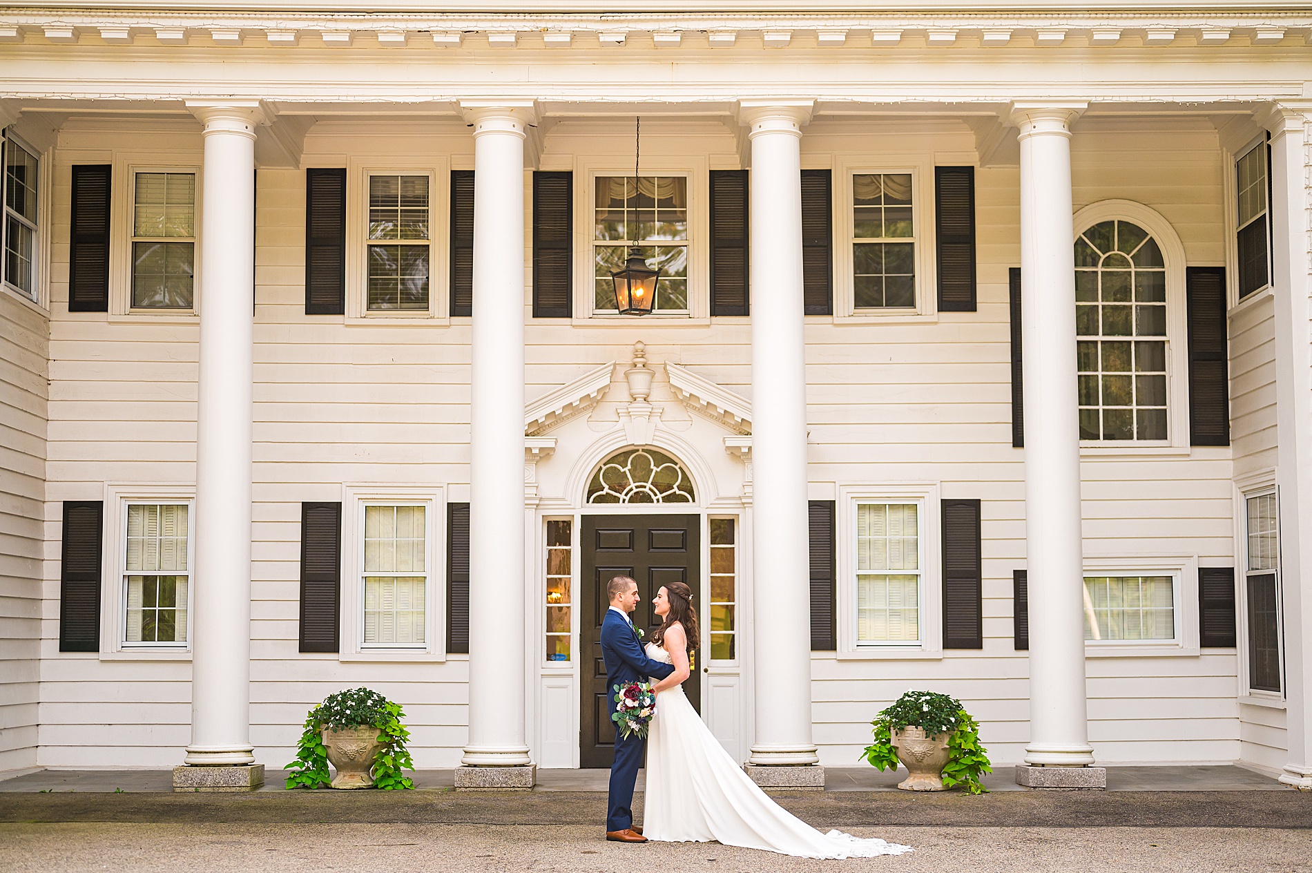 bride and groom portraits in front of the mansion at The Hellenic Center