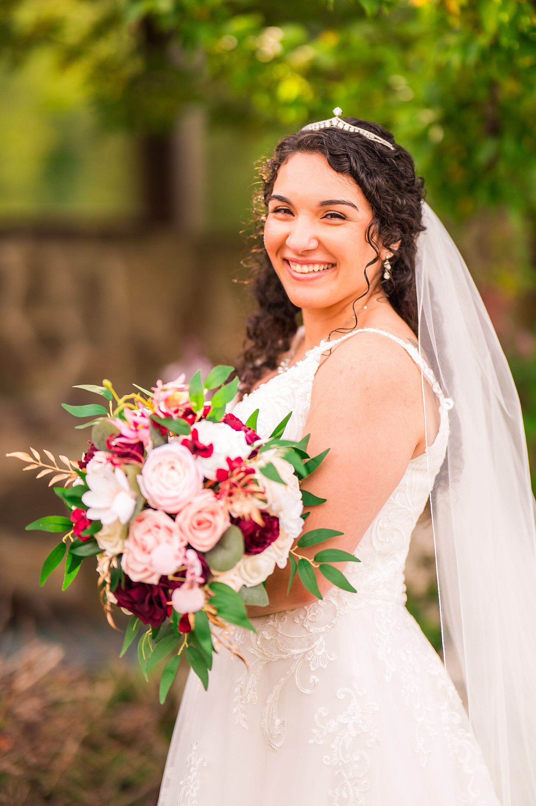 bridal portraits holding romantic white, blush pink, and red rose bouquet