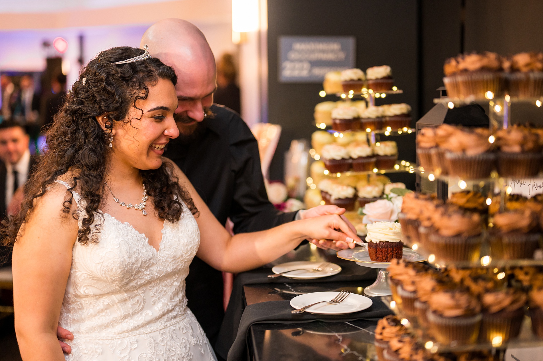 bride and groom cut cupcake 