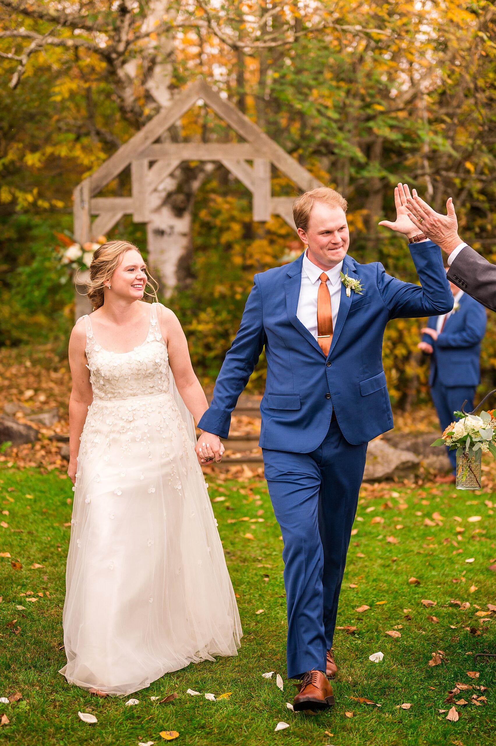 groom gets high five as newlyweds exit wedding ceremony 