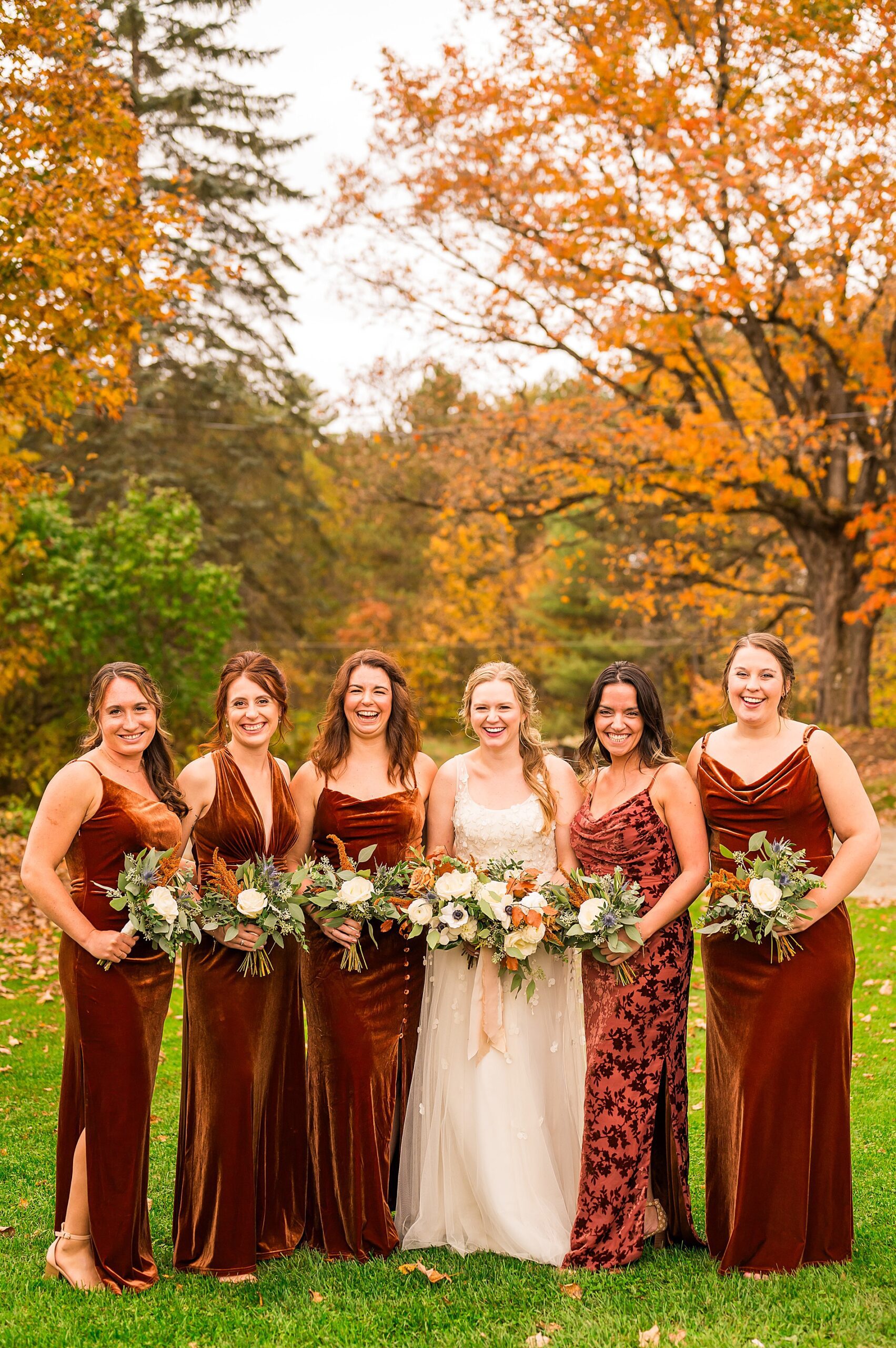 bride and bridesmaids in copper velvet dresses 