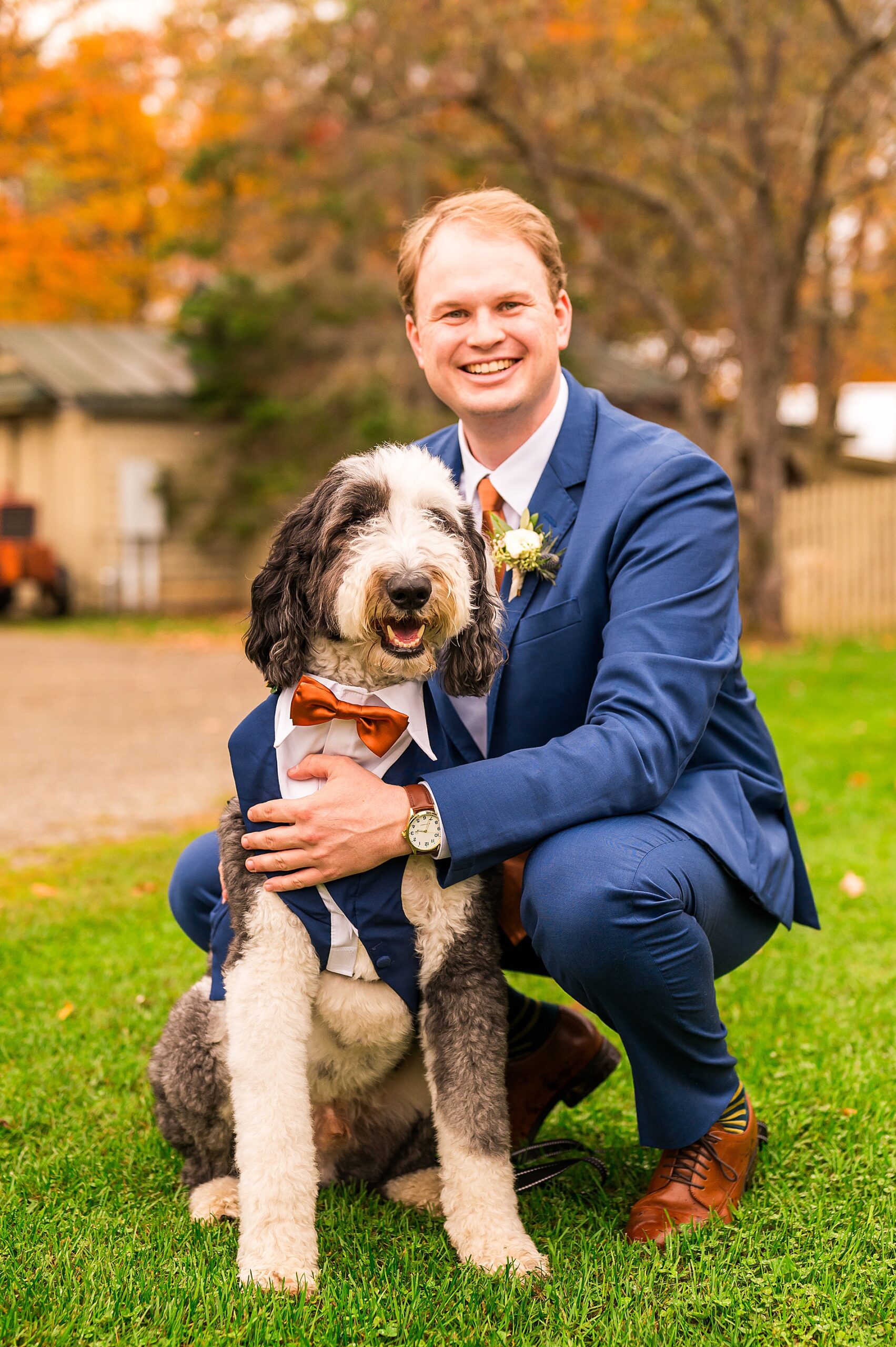 groom with dog in tux