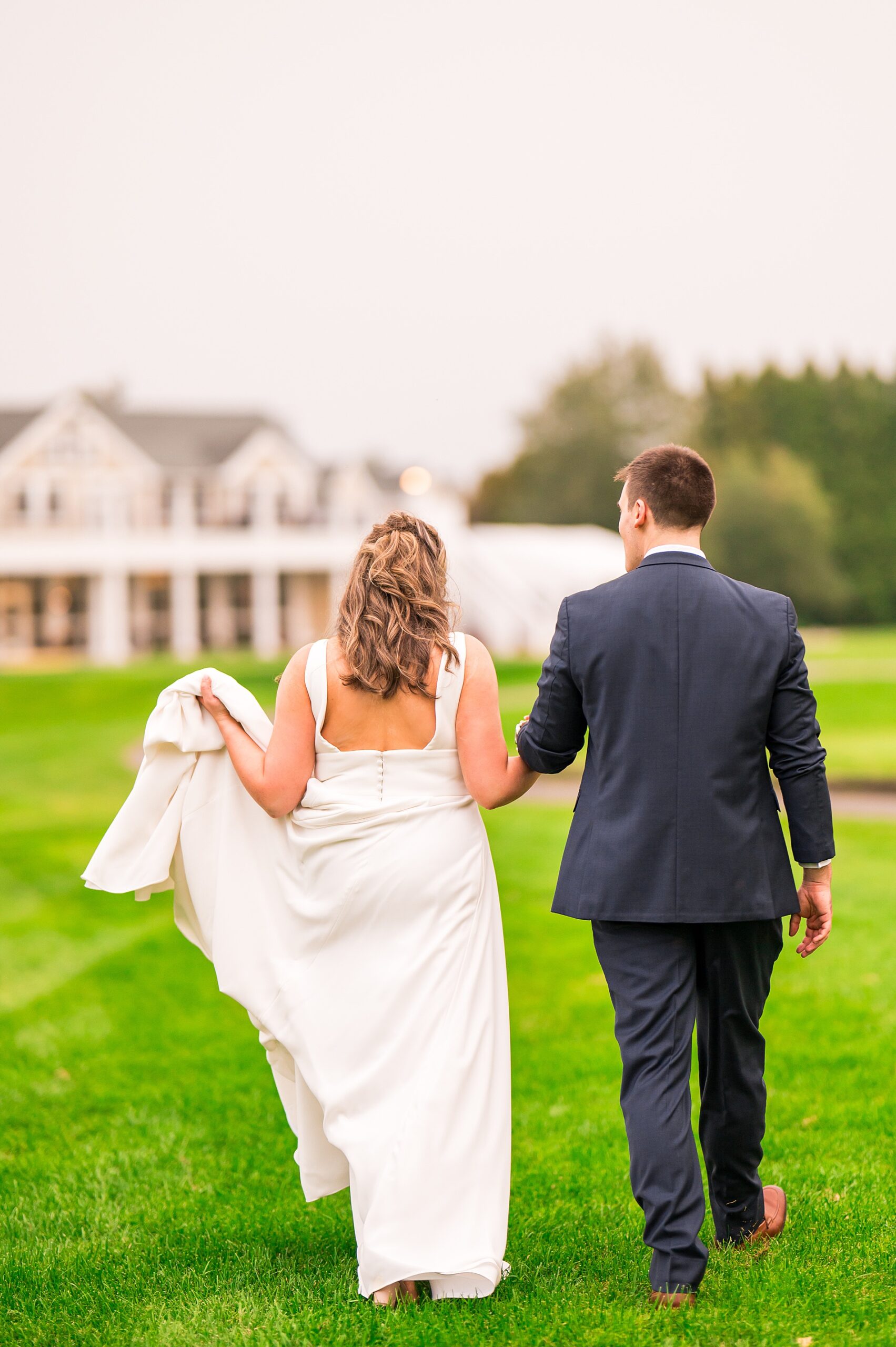 newlyweds walk back to Manchester Country Club, a New Hampshire wedding venue