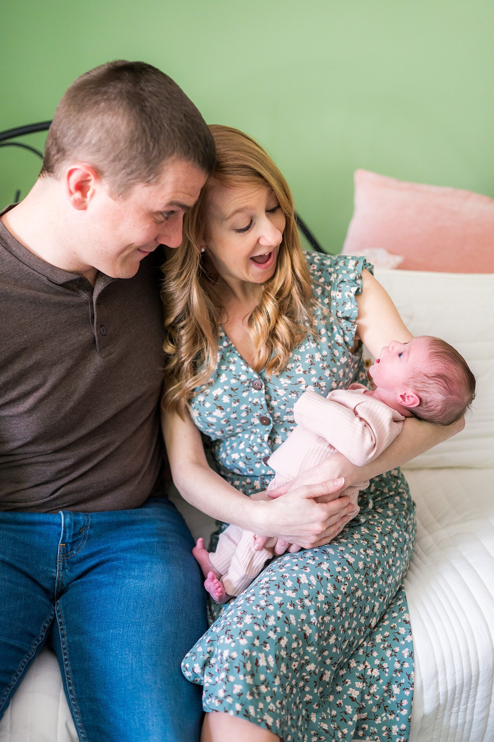 new parents hold their baby girl