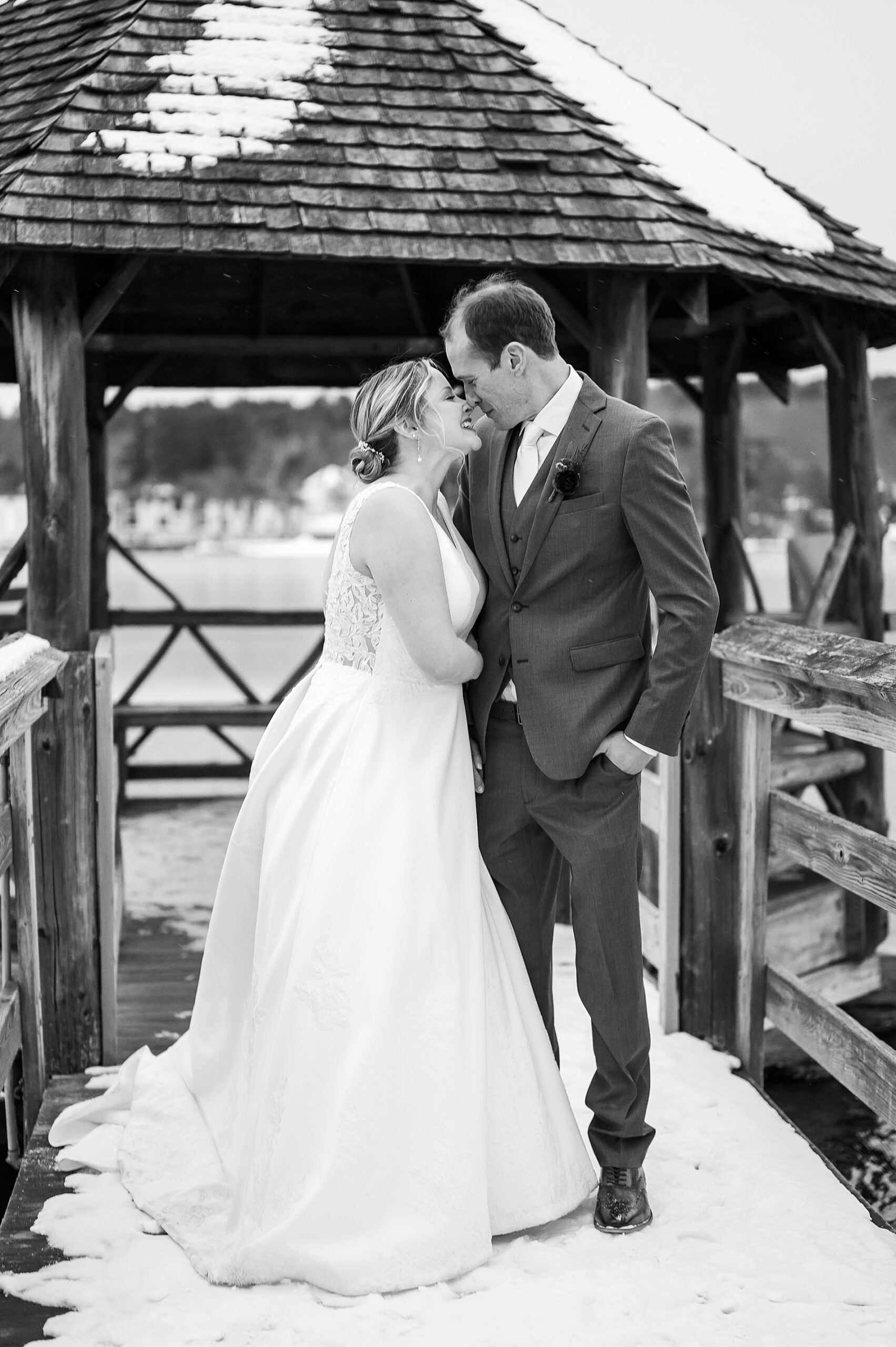 candid wedding portraits on the dock by lake 