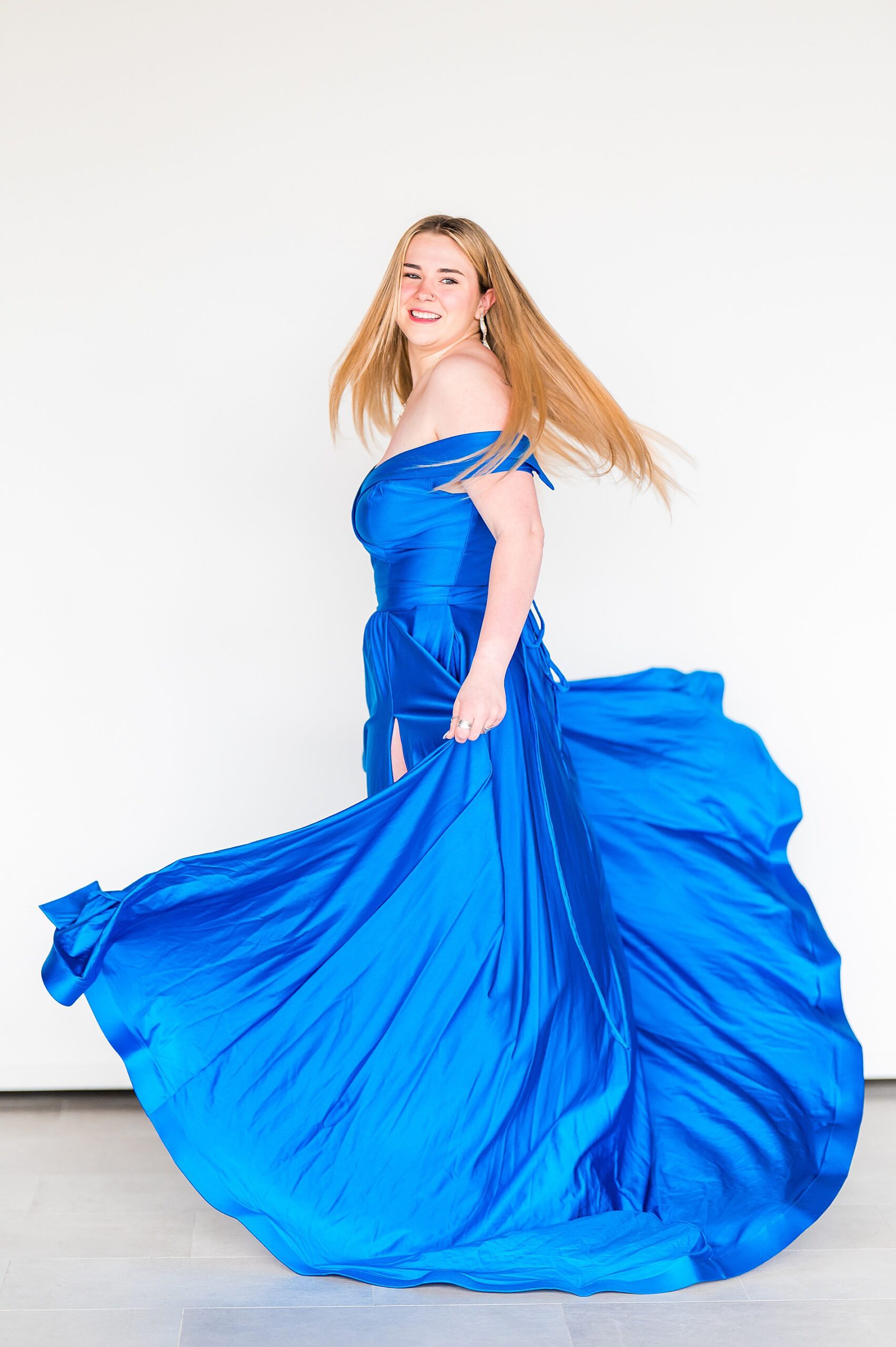 senior twirls in dark blue dress