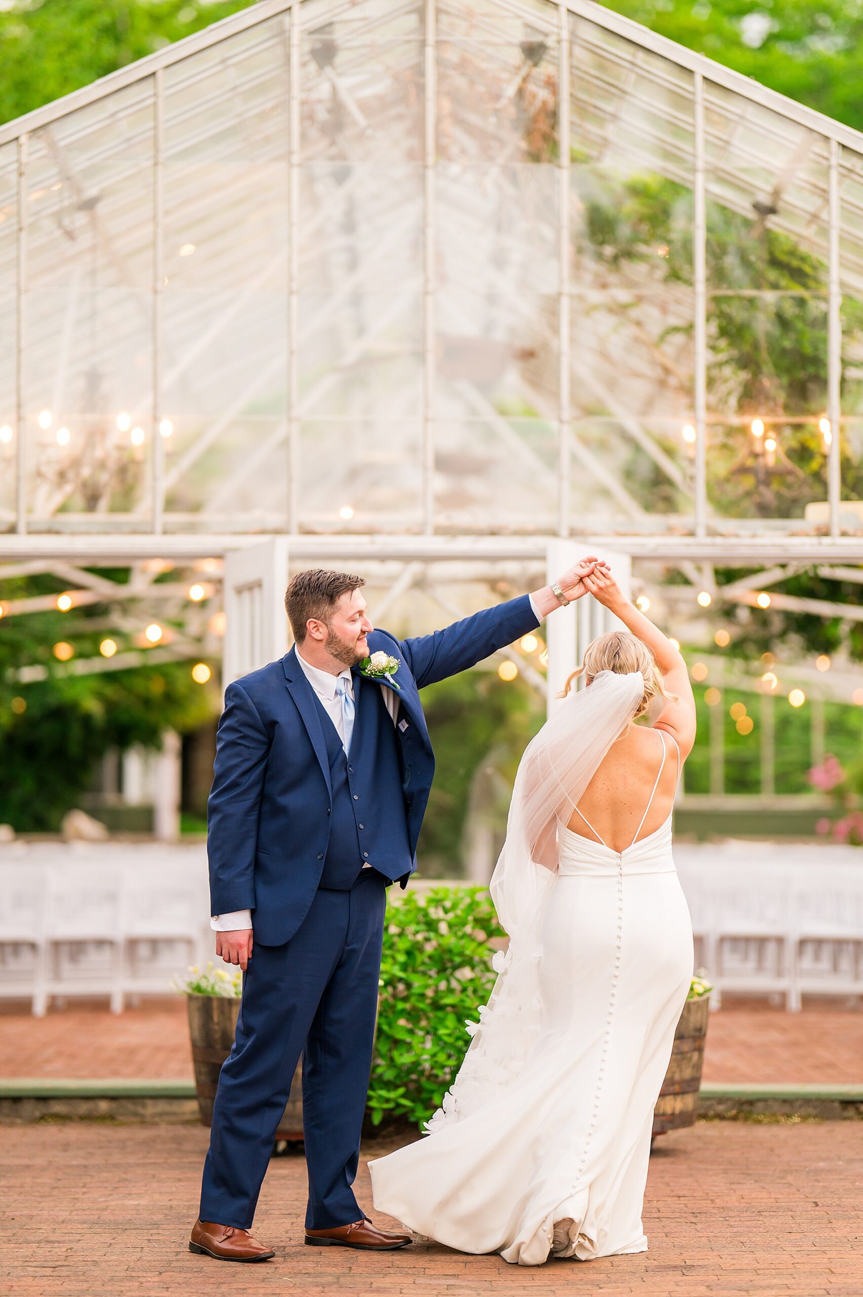 bride and groom dance outside the greenhouse
