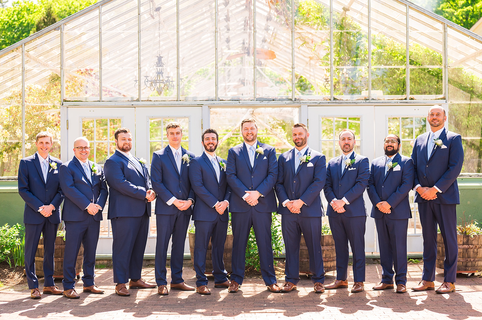 groom and groomsmen portraits outside the greenhouse at The Barn on the Pemi 