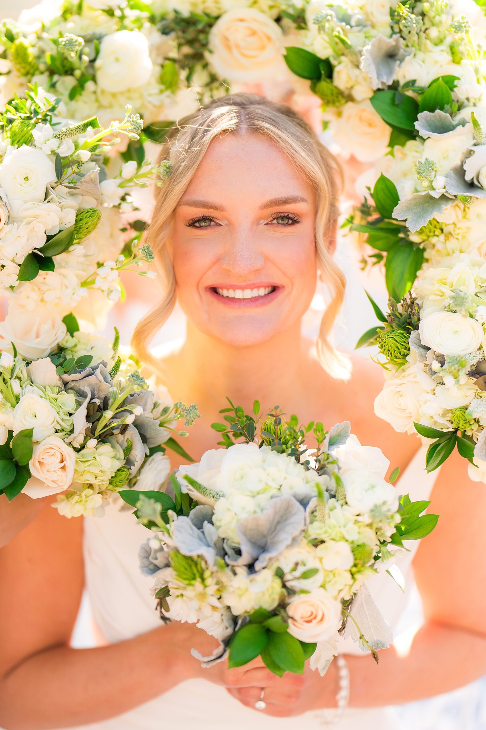 bridal portraits with white flower bouquets surrounding her 