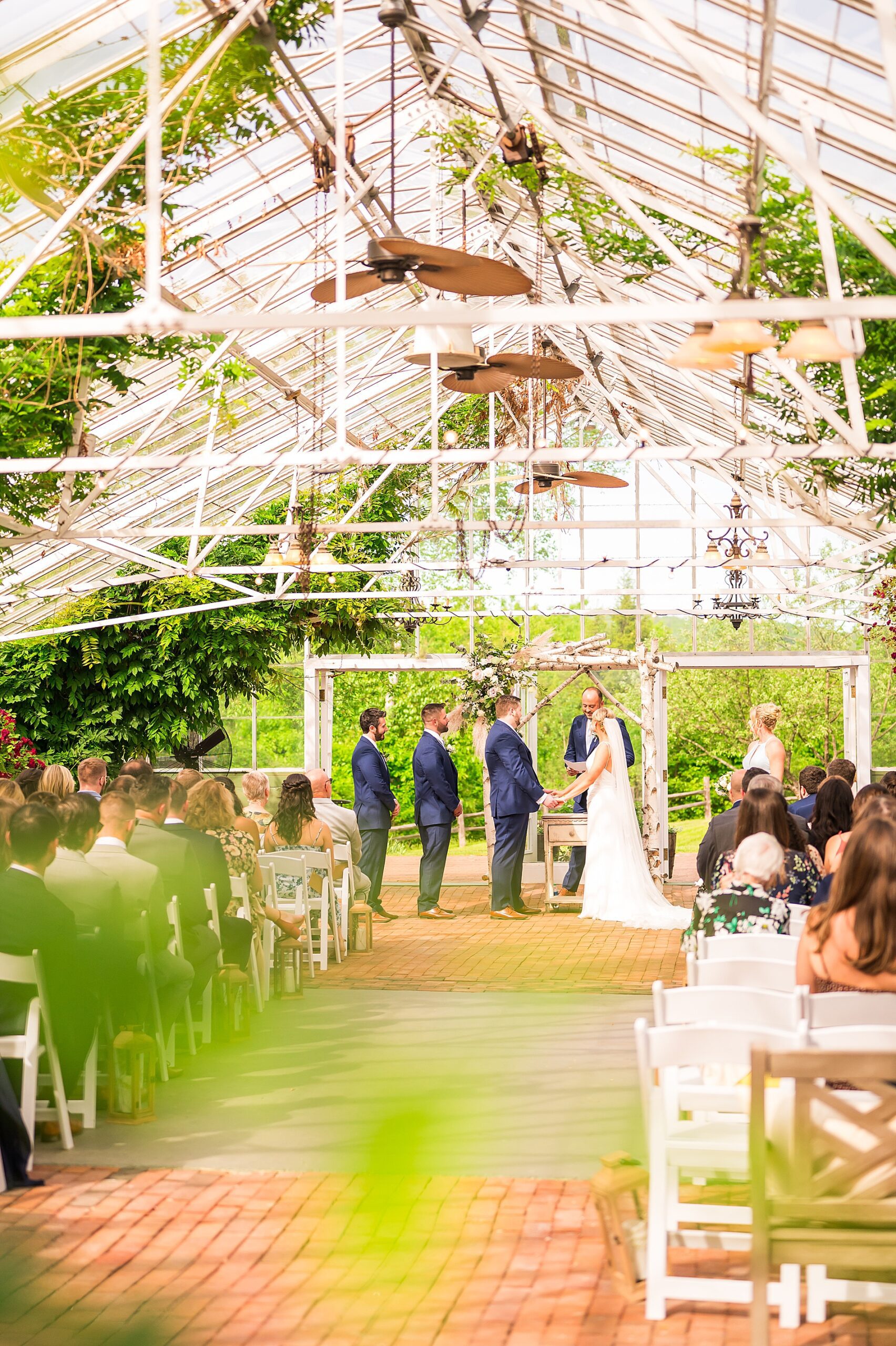 Elegant Spring Wedding ceremony in the greenhouse at The Barn on the Pemi 
