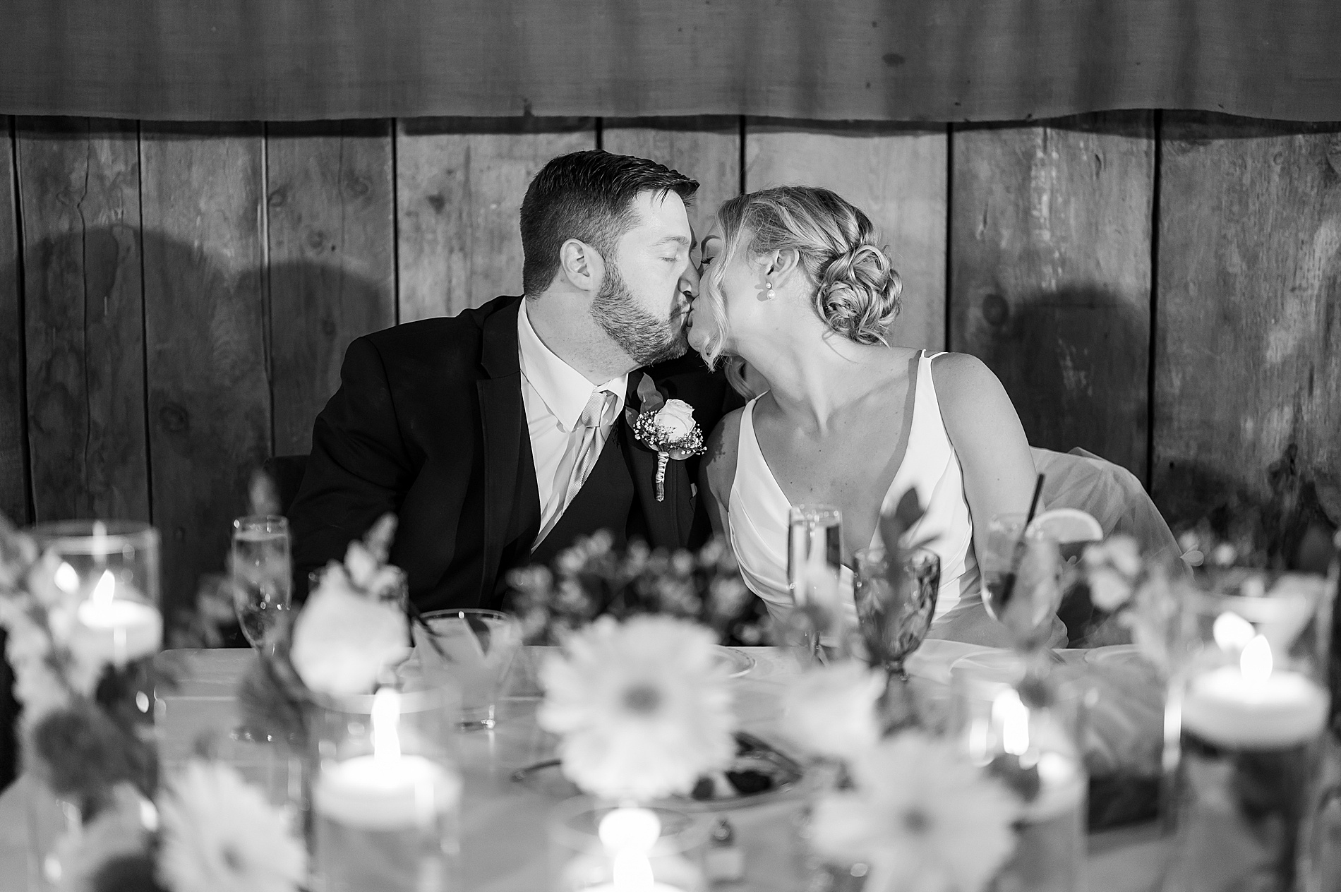 newlyweds kiss at wedding reception 