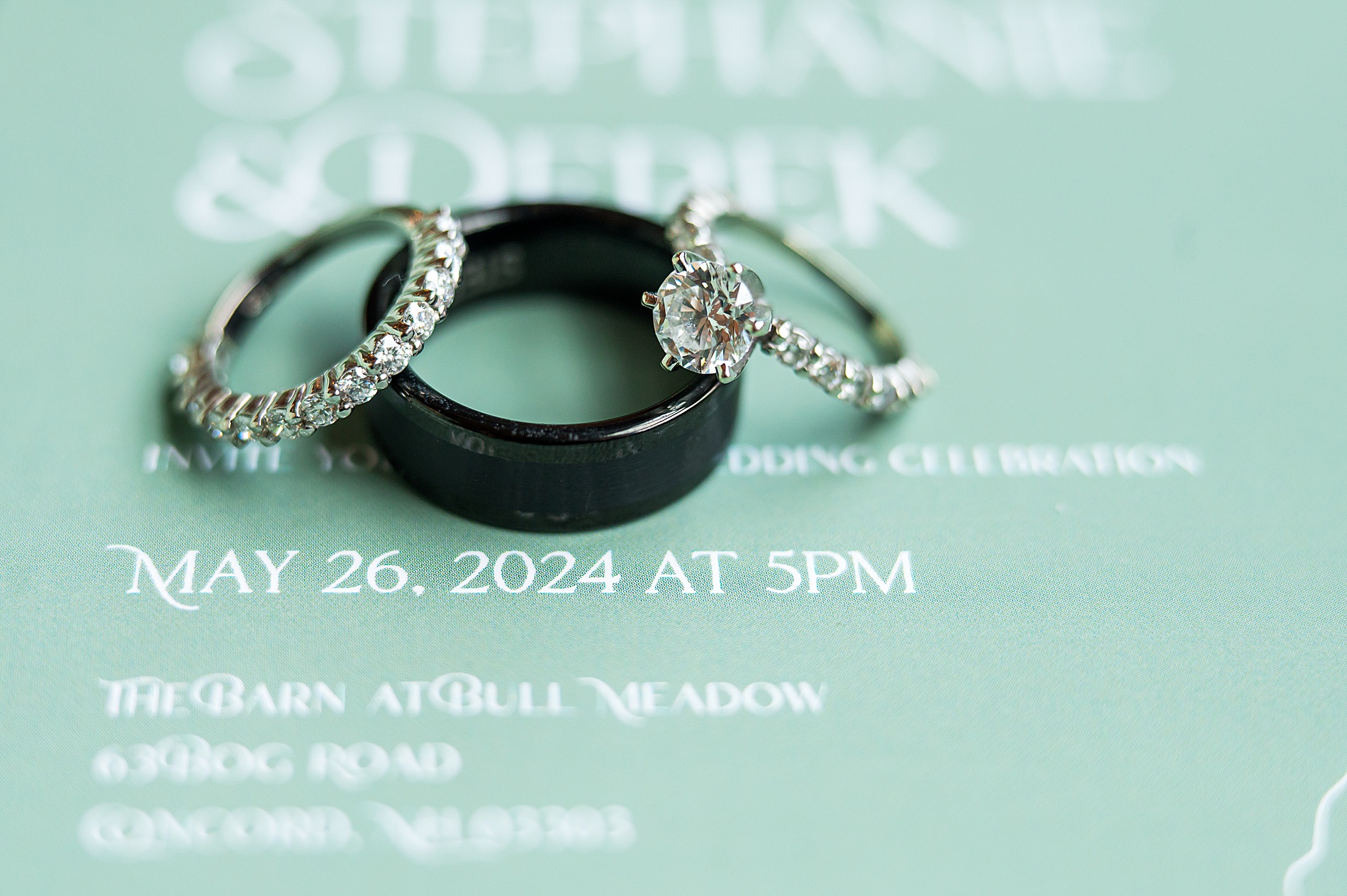 wedding rings on sage green invitations