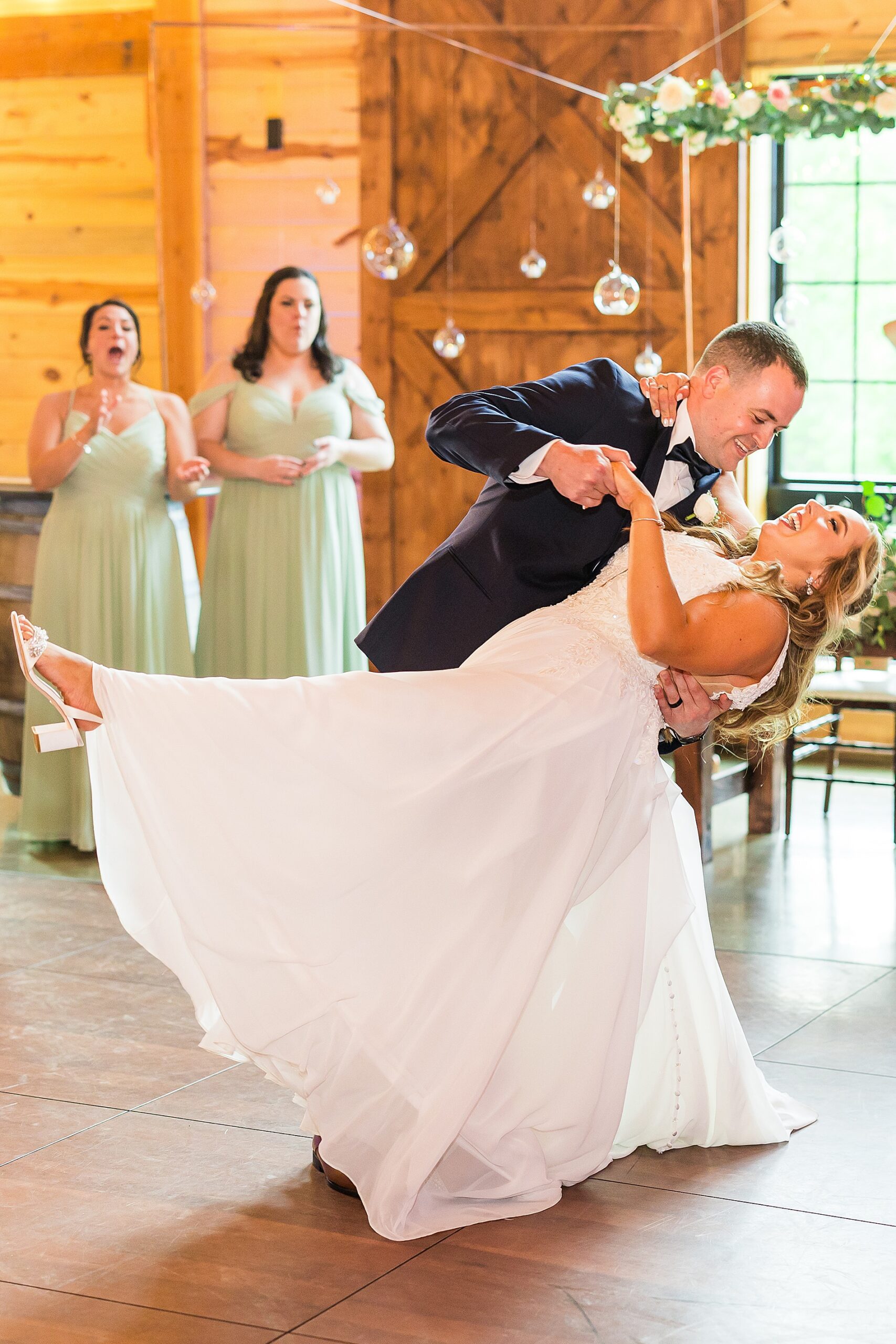 groom dips bride on the dance floor
