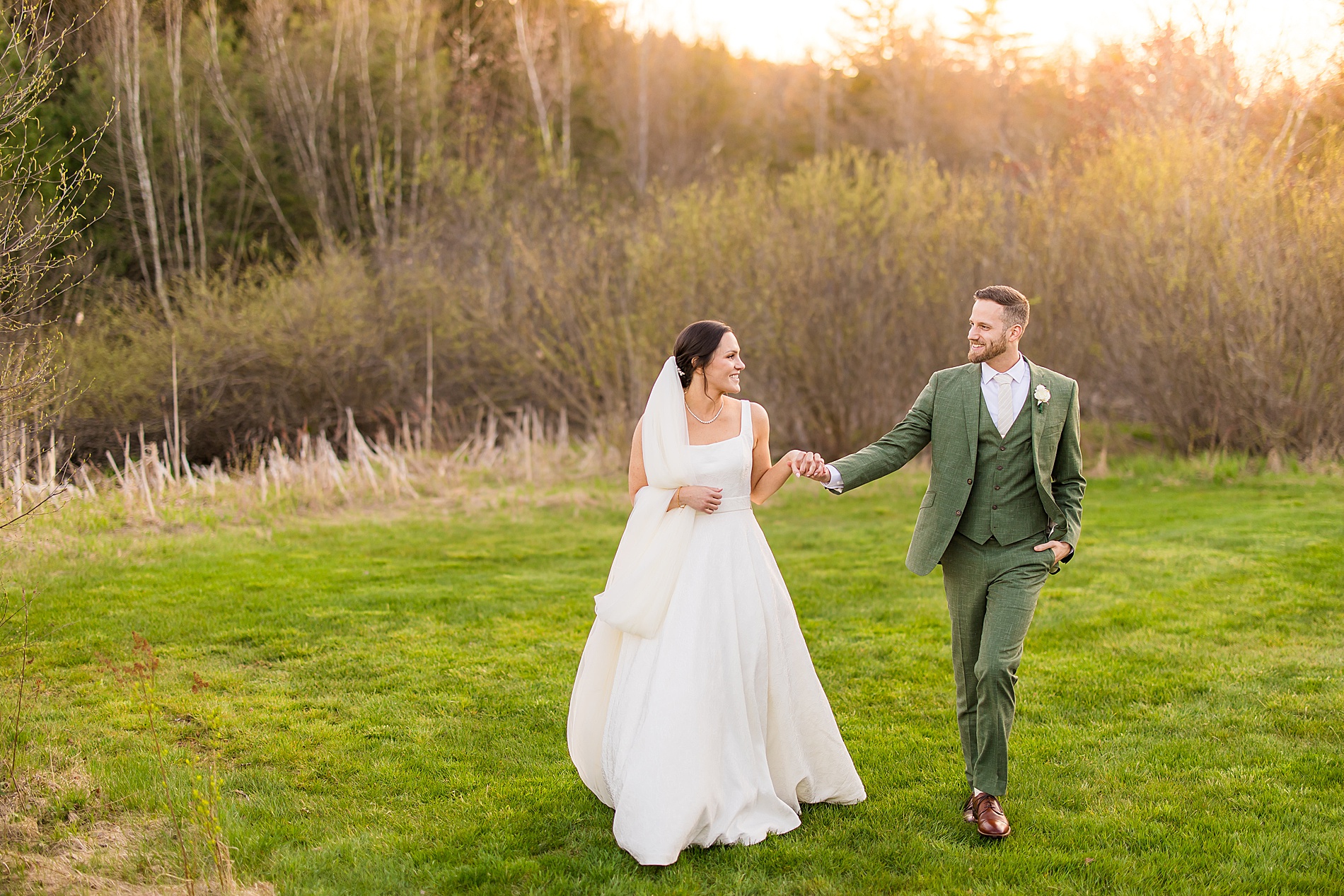 newlyweds hold hands while walking together