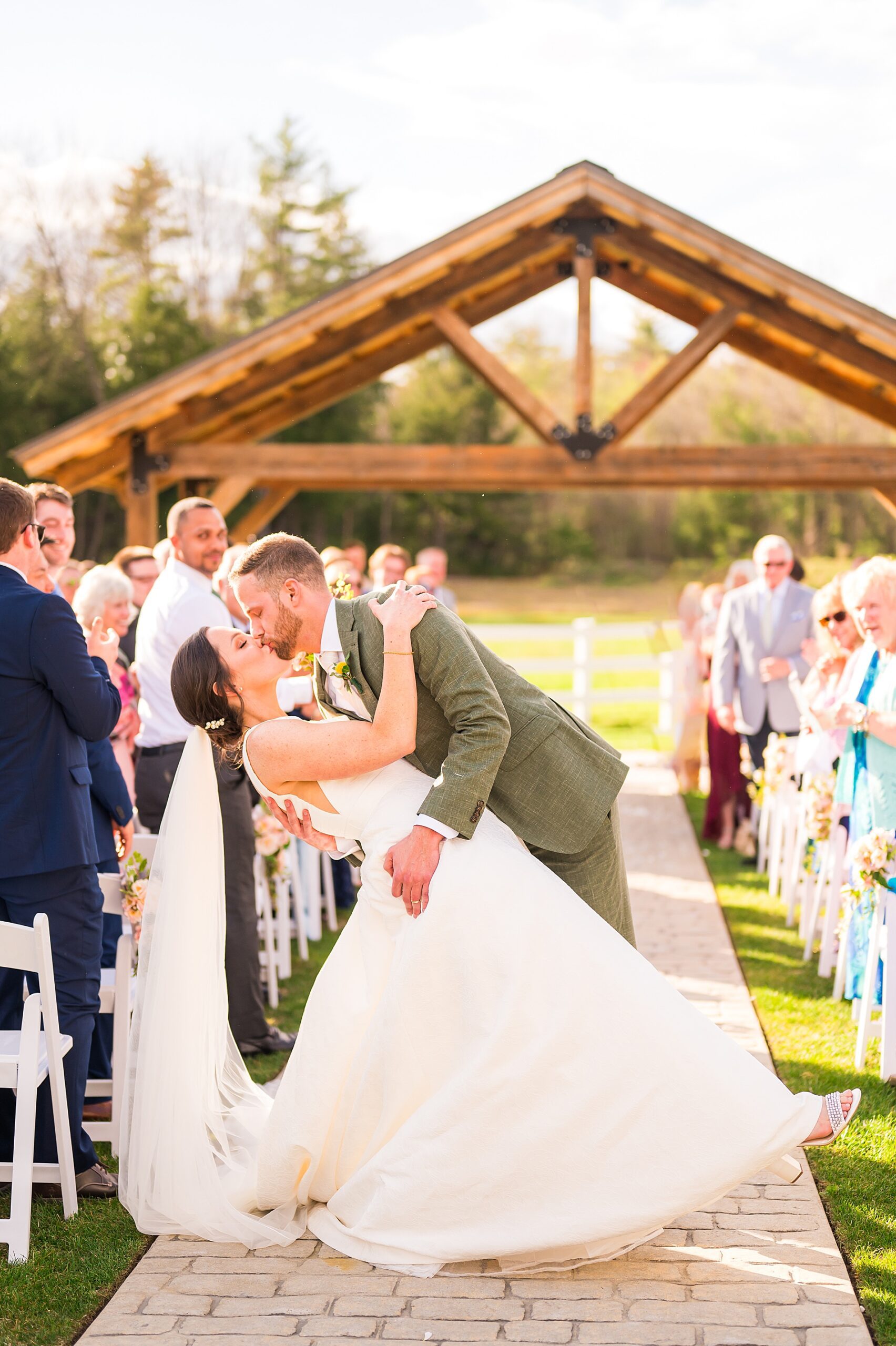 newlyweds kiss as they exit wedding ceremony 