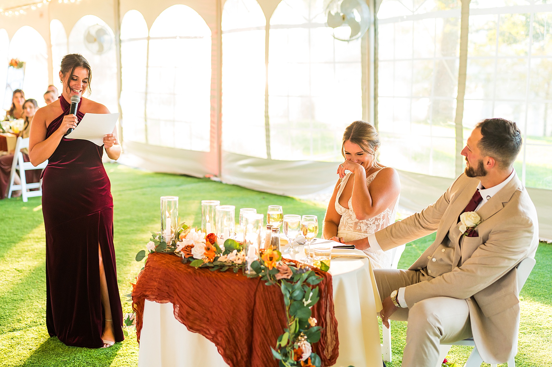 bride and groom laugh during wedding speech