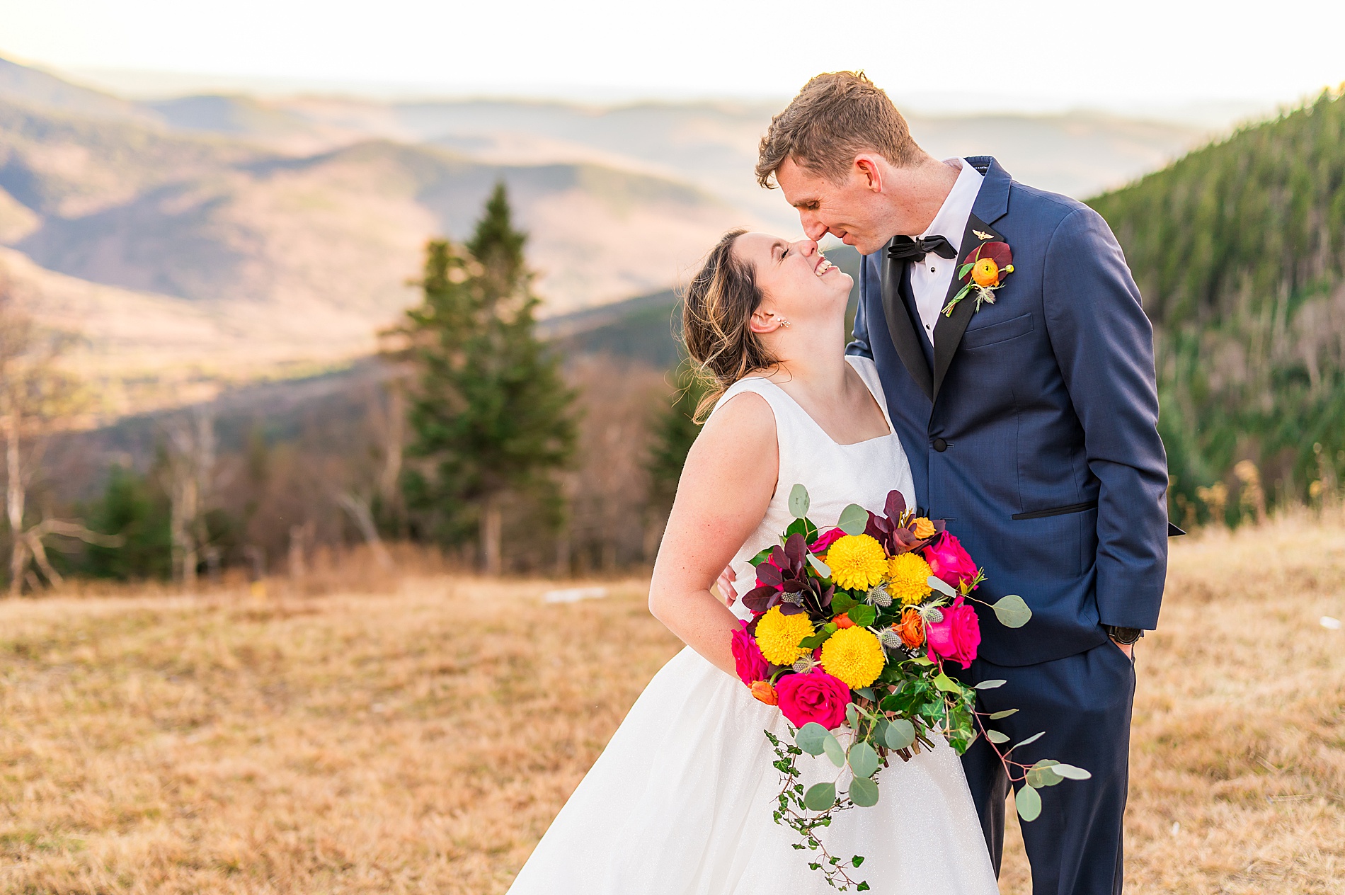 newlyweds kiss on mountaintop 