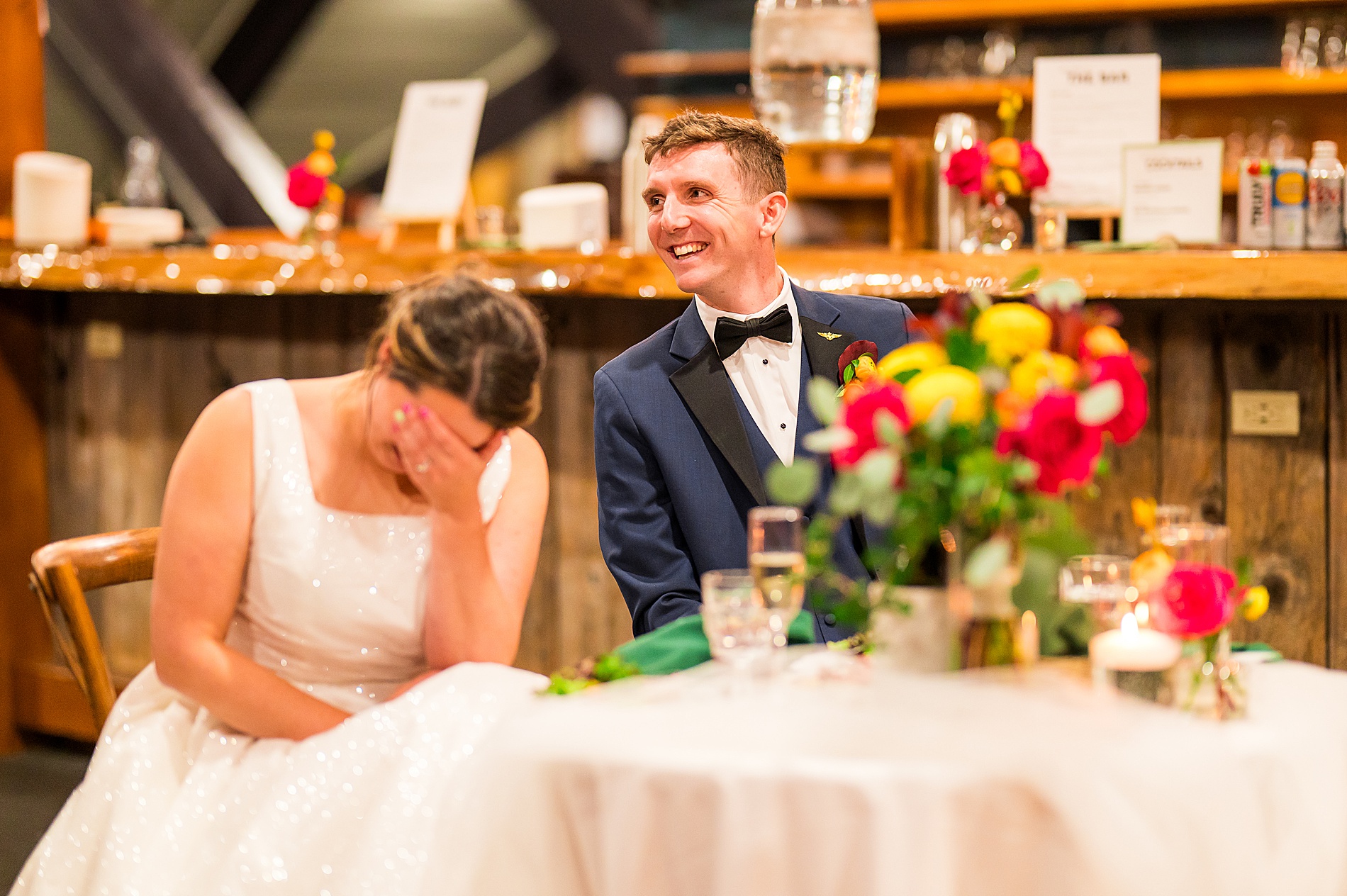 bride and groom laugh during wedding toast