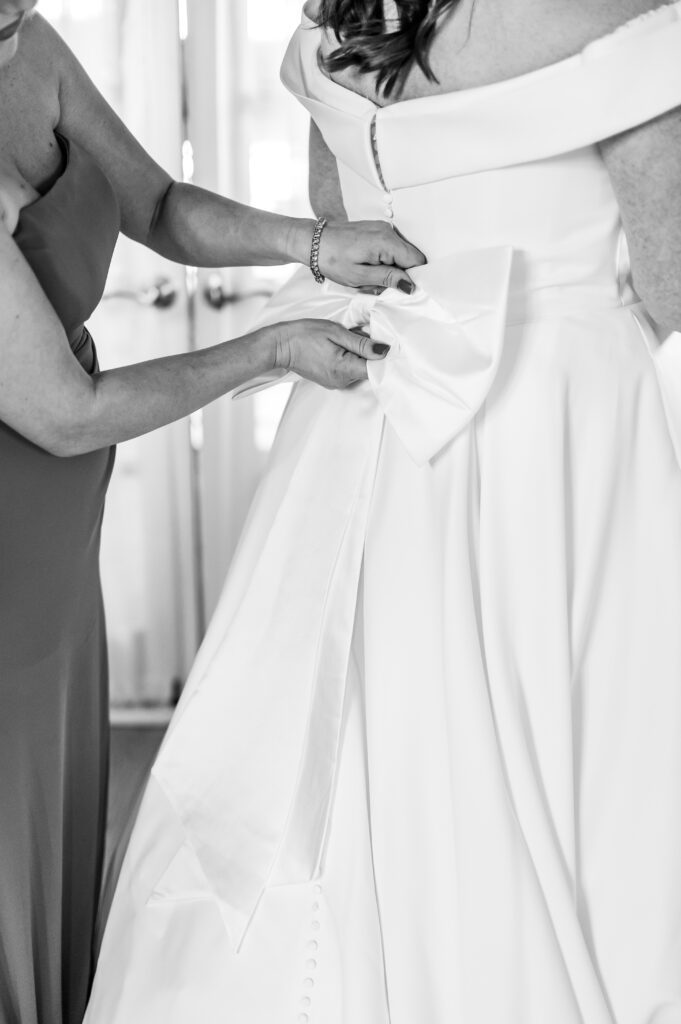 Maid of honor tying bow