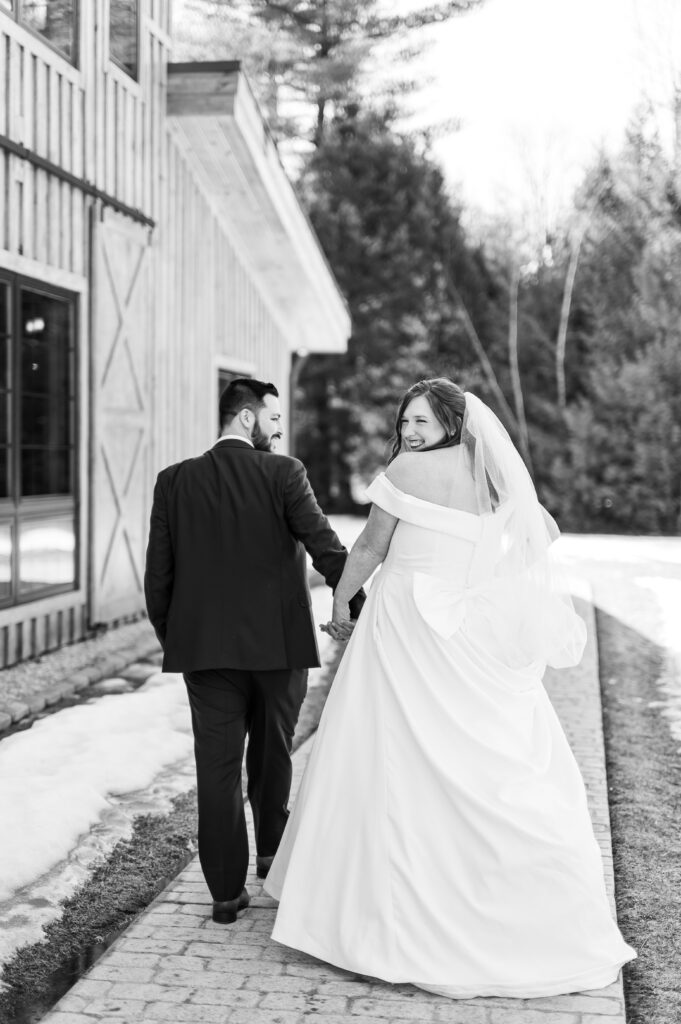 Bride looking over shoulder | March wedding at the barn at bull meadow