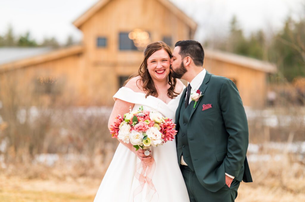 Groom kissing bride | March wedding at the barn at bull meadow