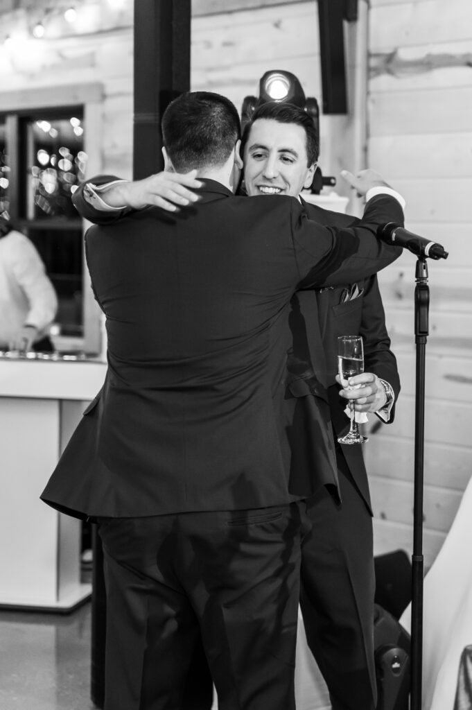 Groom and best man hug