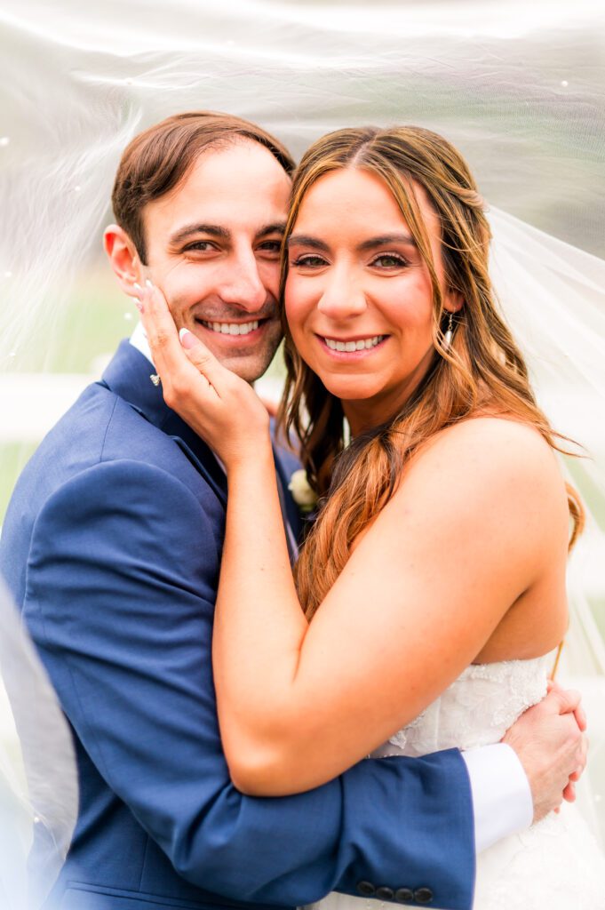 Bride and groom under veil | Dusty blue wedding