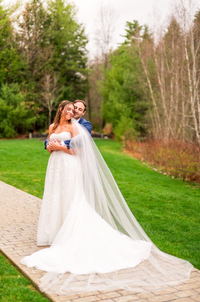 Bride and groom in front of barn