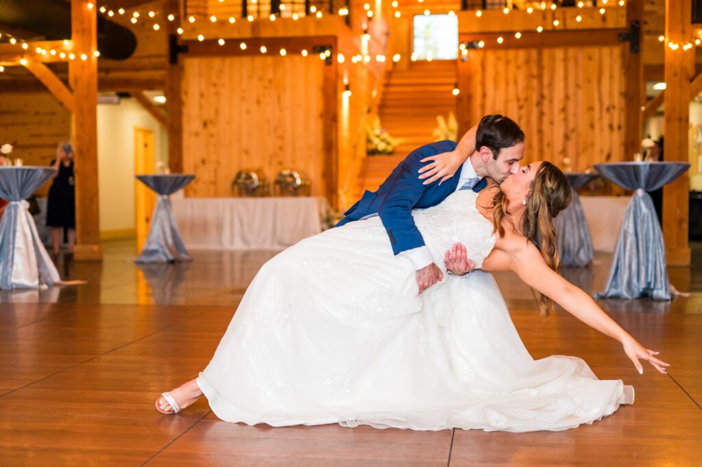 Bride and groom first dance dip kiss